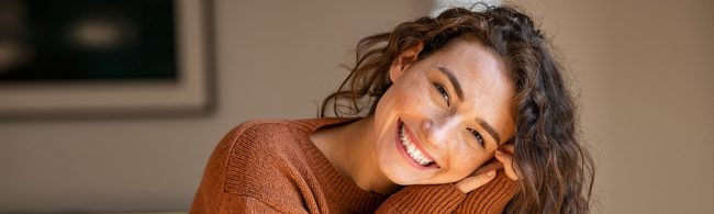 Persoon in een schemerig winterse setting, licht van een wake-up lamp en knusse sfeer — symboliseert het tegengaan van een winterdip met licht en warmte.