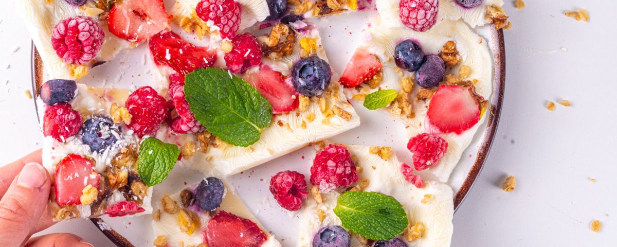 Frozen yoghurt bites met bessen en chocolade, gezonde en frisse snack.